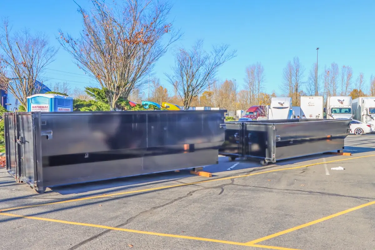 Professional dumpster rental service with roll-off container on residential driveway in Blanchard